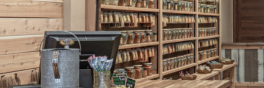 The Spice & Tea Exchange store's inside - checkout with spice blends on wall.