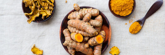 Fresh turmeric on plate.