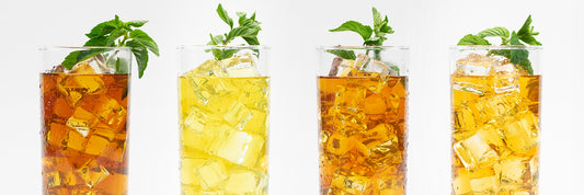 Iced tea in glasses of various shades of yellows and browns.