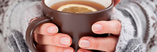 Tea in mug held by hands