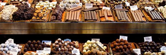 Various candies in window at chocolate shop.