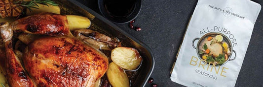 All-Purpose Brine Seasoning sitting next to a perfectly browned turkey in a pan