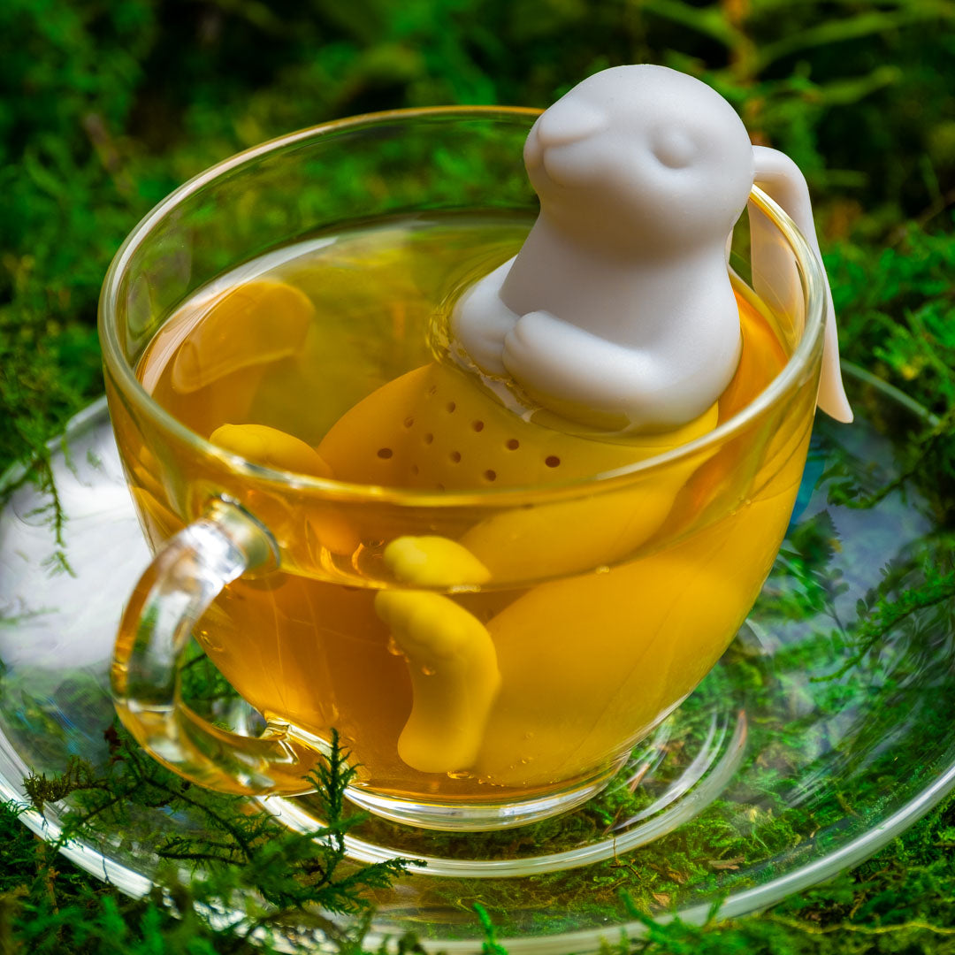 Bunny Silicone Tea Infuser in brewed yellow herbal tea in clear glass mug