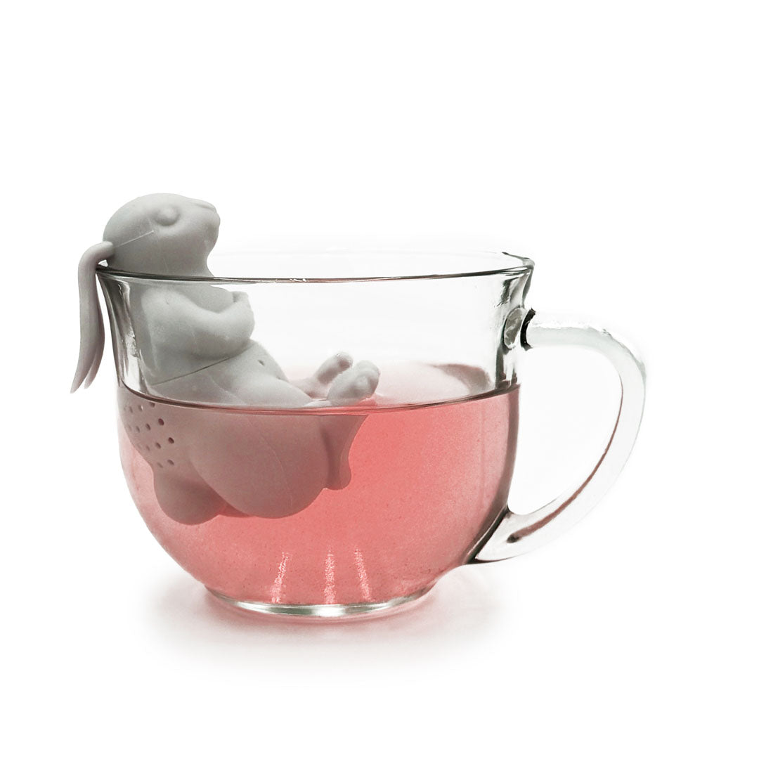 Bunny Silicone Tea Infuser in clear glass mug filled with brewed pink herbal tea