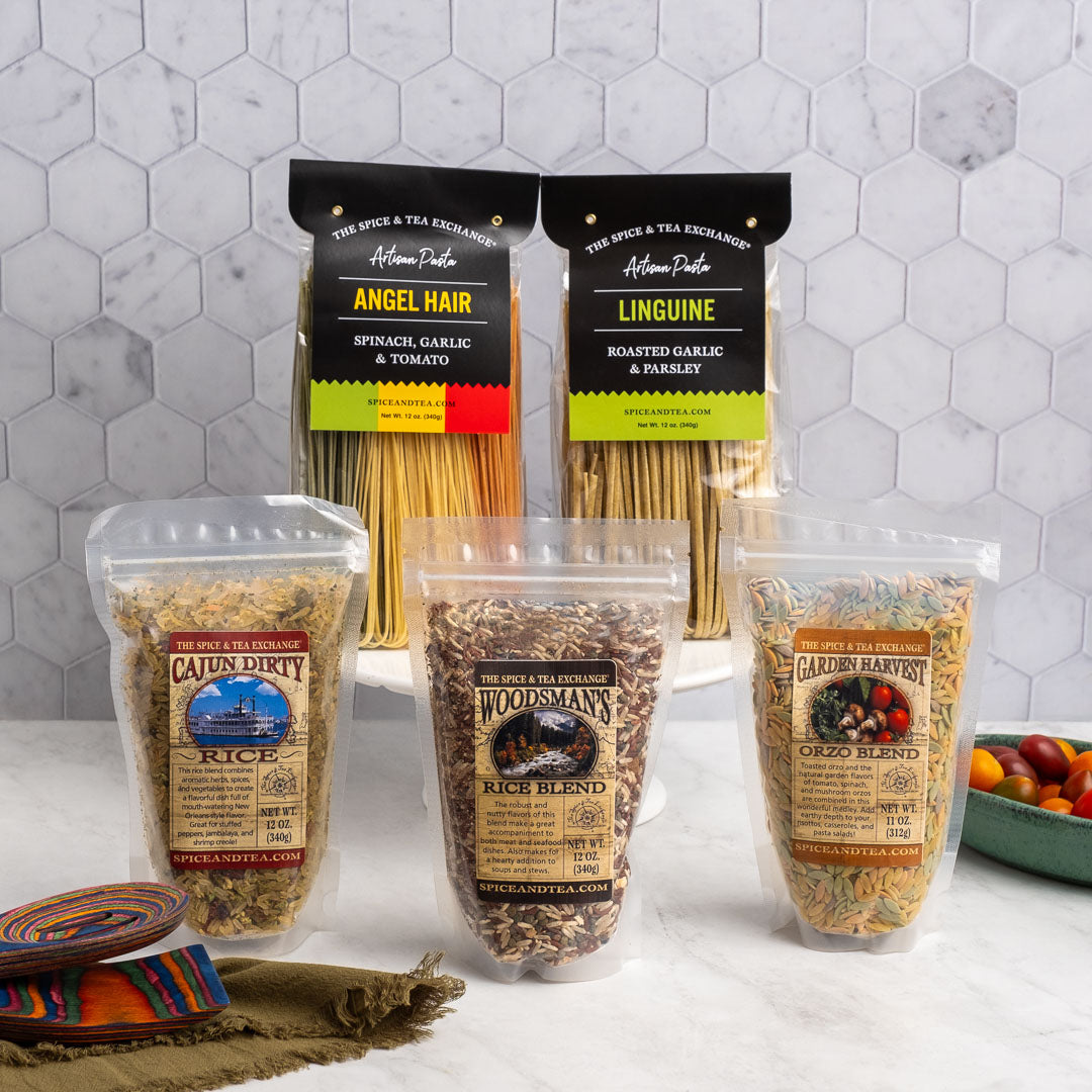 Cajun Dirty Rice, Rainbow Angel Hair, Roasted Garlic and Parsley Linguine, Woodsman's Rice Blend, and Garden Harvest Orzo Blend all displayed in packaging 