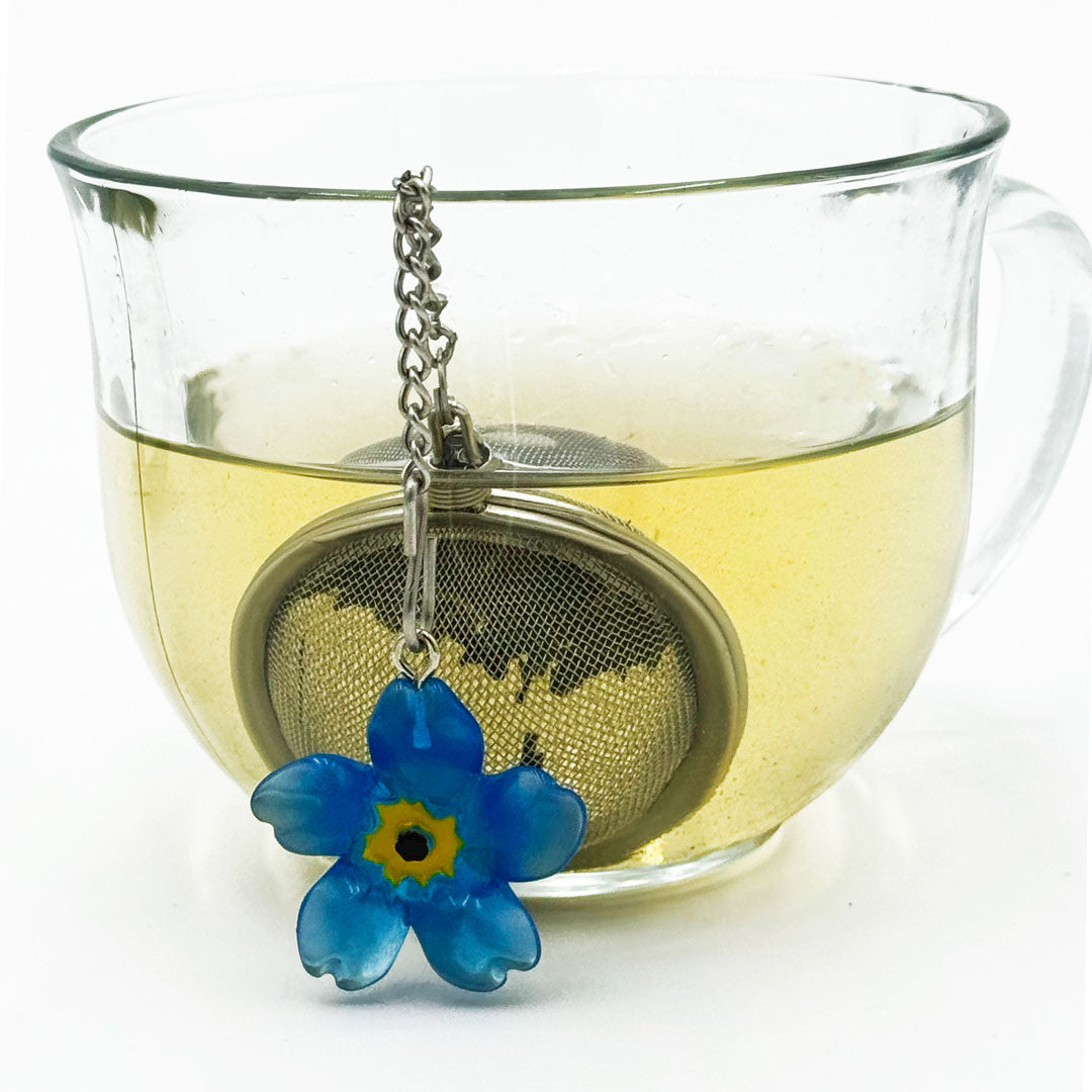 Blue Flower Charm Infuser in Steeped Tea in Glass Mug