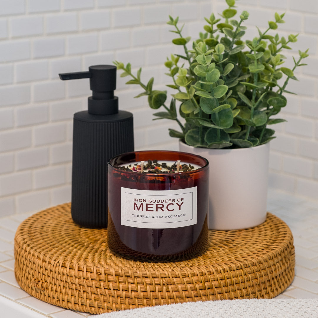 Iron Goddess Of Mercy Candle next to soap dispenser and green plant