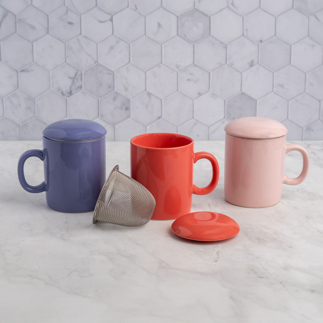 Periwinkle Infuser Mug displayed with red and pink mugs