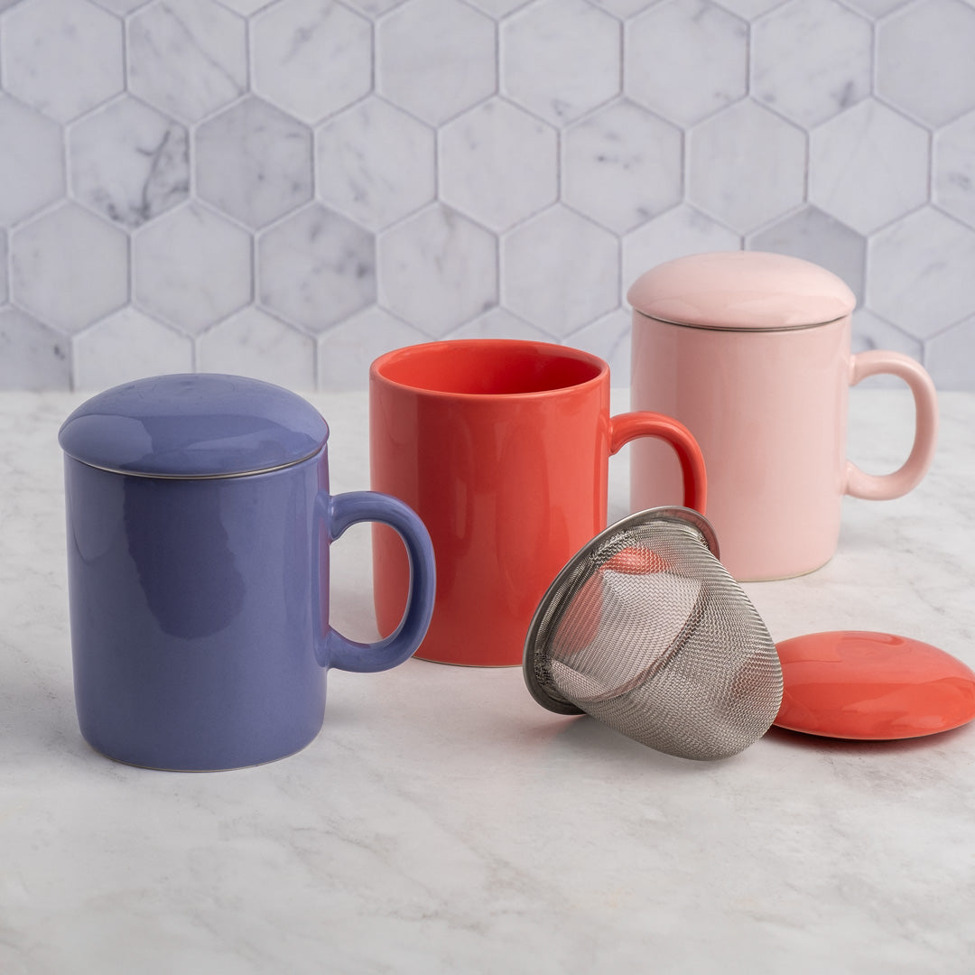 Periwinkle Infuser Mug displayed with red and pink mugs