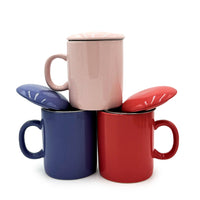 Periwinkle Infuser Mug displayed with red and pink mugs