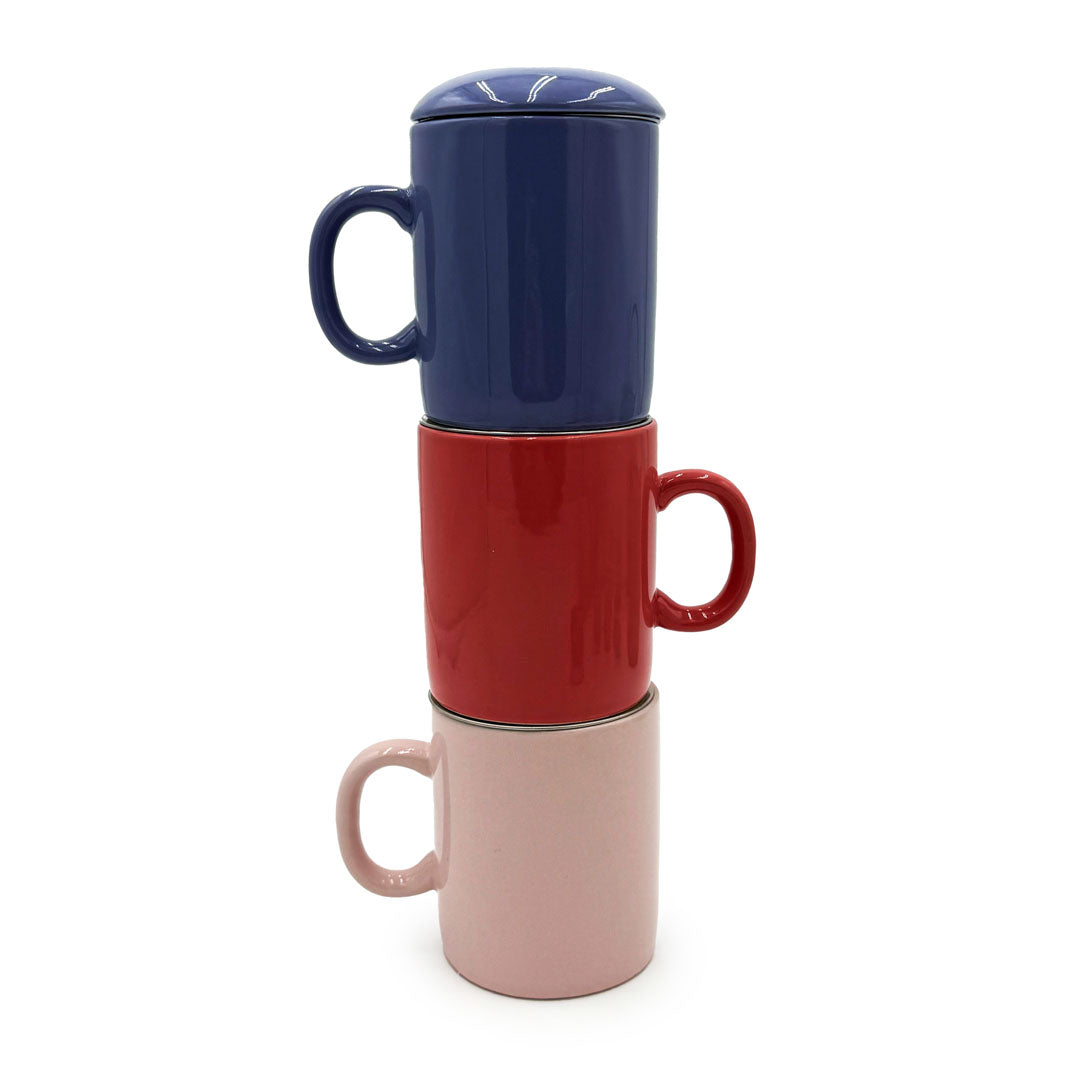 Periwinkle Infuser Mug displayed with red and pink mugs