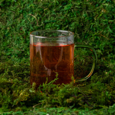 Roots Revival Herbal Tea on green earthy background