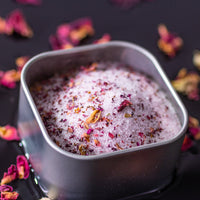 Rose Sugar in square tin surrounded by rose petals